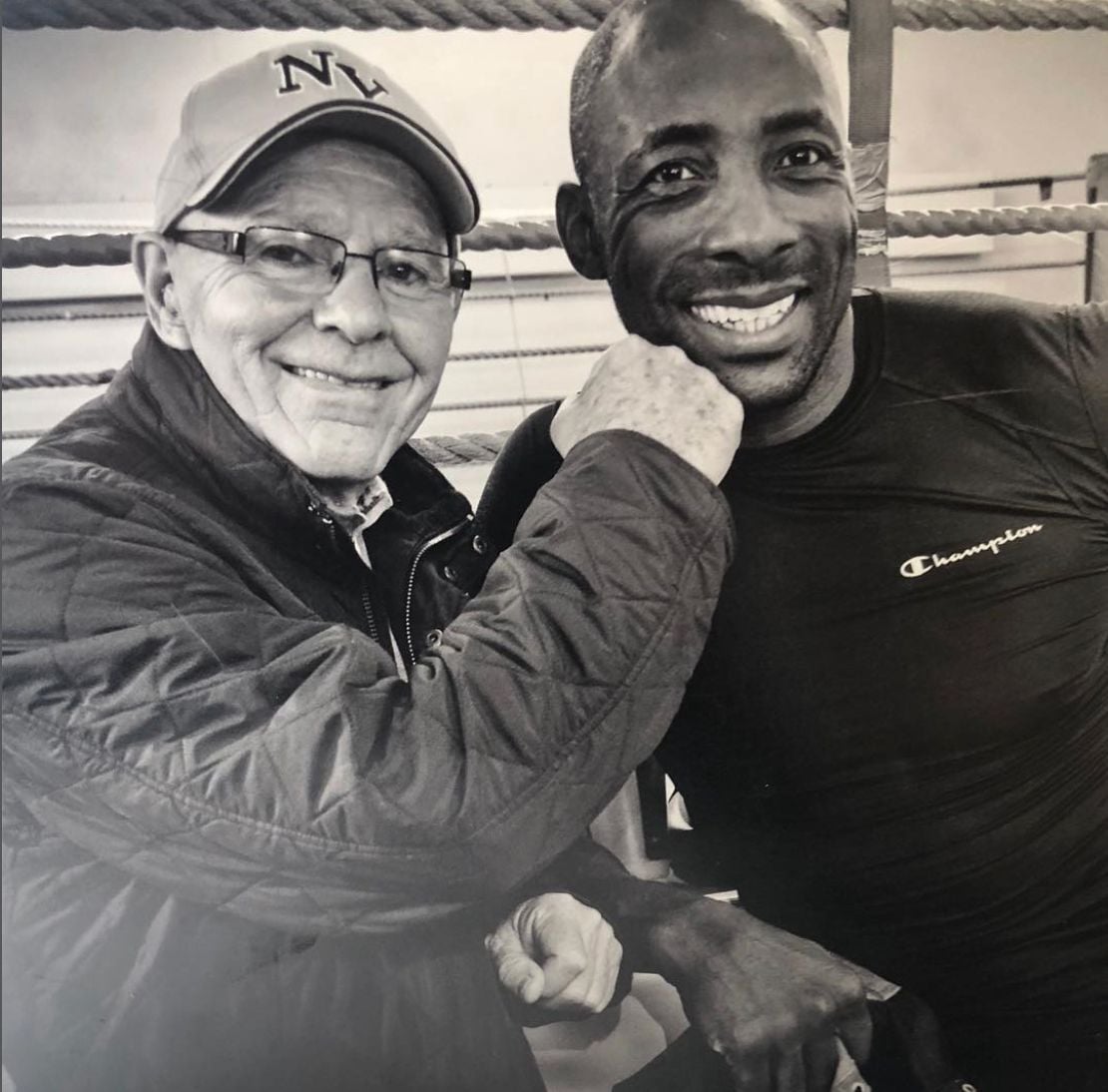 Johnny Nelson MBE with his mentor Brendan Ingle MBE in a boxing ring.
